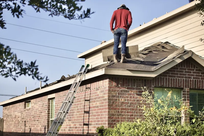Professional roofer working on a residential roof in Usaf Academy